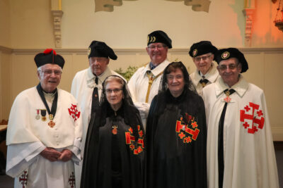 NZ Vigil 2024, foundational members of the Order in New Zealand. Front row from left: Fr Anthony Malone OFM KCHS, Dame Suzie McCarthy DCHS, Dame Patricia Gribble DCHS, Knight Jim Gribble KCHS. Back row: Knight Jack Gibbs KGCHS, Vice Governor-General John Secker KGCHS, Knight Pat McCarthy KCHS.