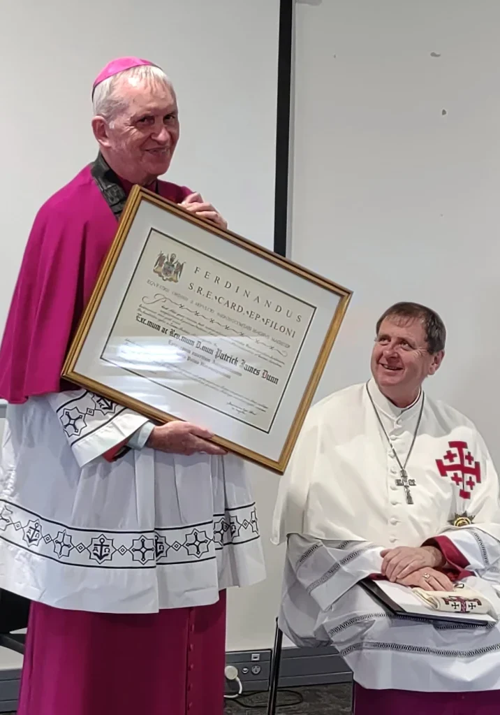 displaying-the-award-by-bishop-patrick 3-7-2022- Emeritus Bishop Patrick Dunn KC*HS displaying the Gold Palm Document