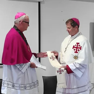 3-7-2022- Emeritus Bishop Patrick Dunn KC*HS presenting a white stole with the emblazoned cross to the new Grand Prior Bishop Stephen Lowe KC*HS